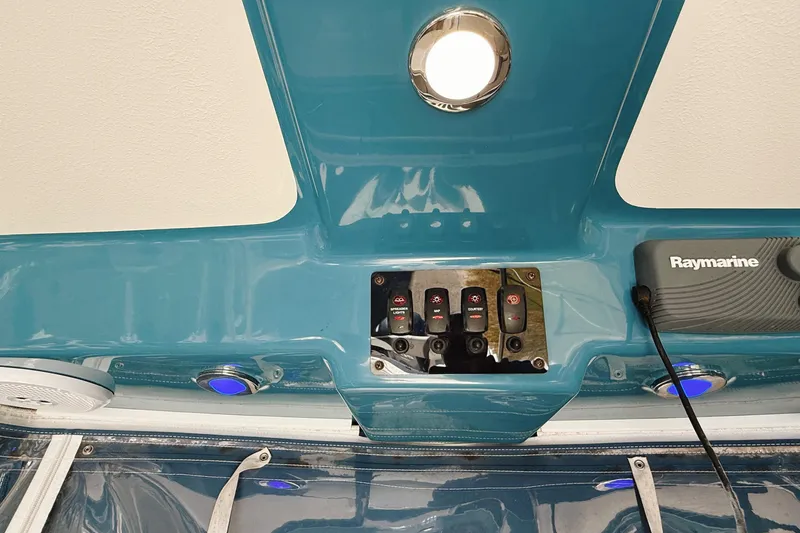 Slide: The Image of Century 2600 Walkaround 2016 boat dashboard with Raymarine equipment and control switches. - 19