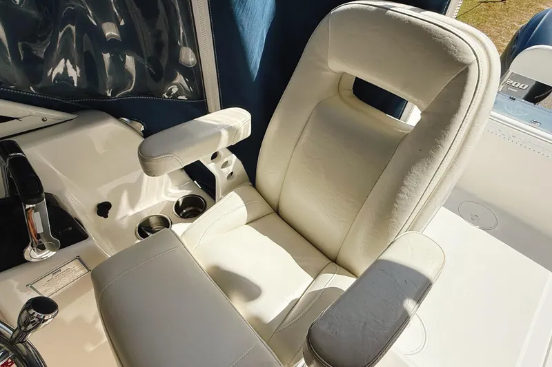 Slide: The Image of Luxurious captain's chair on 2016 Century 2600 Walkaround boat, featuring plush white upholstery. - 21
