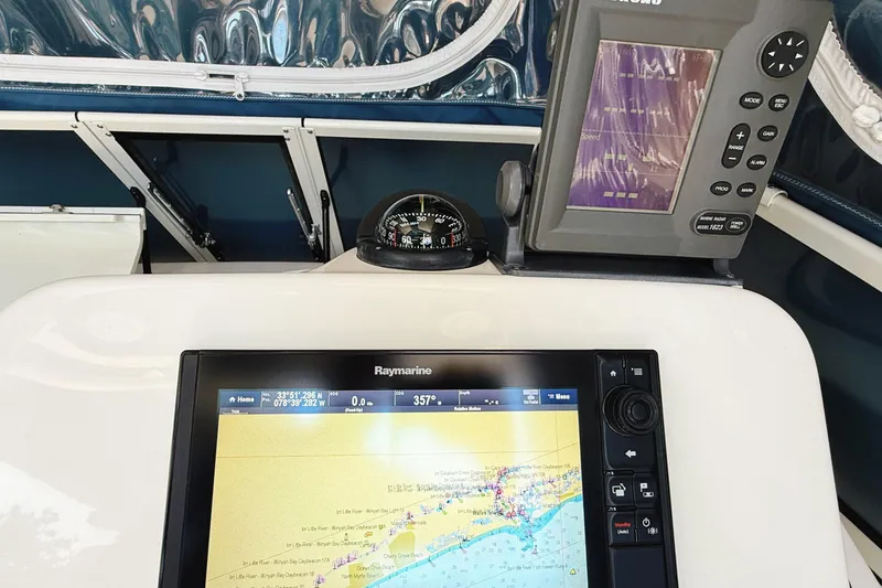 Slide: The Image of Century 2600 Walkaround 2016 boat dashboard with navigation and sonar displays. - 22