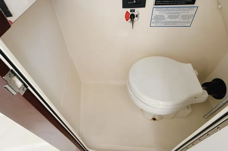 Slide: The Image of 2016 Century 2600 Walkaround boat interior with compact marine toilet. - 24
