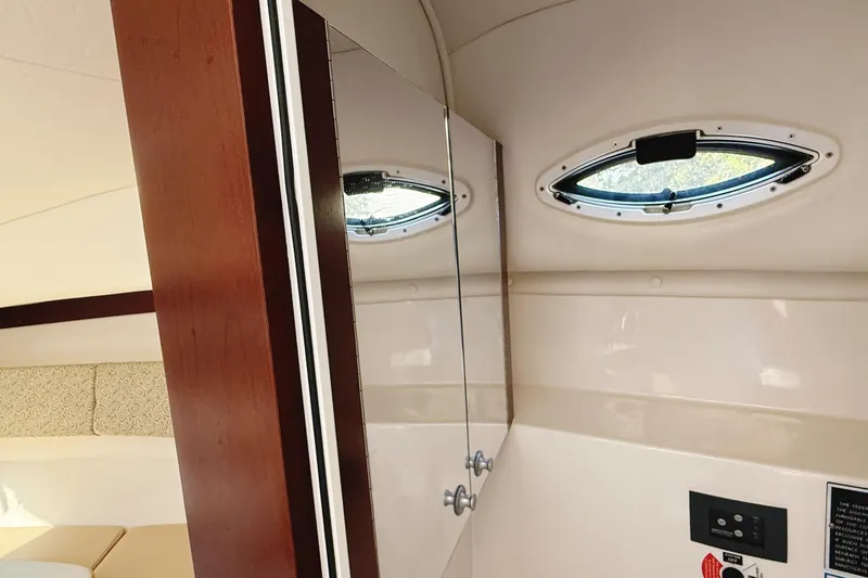 Slide: The Image of Interior cabin of 2016 Century 2600 Walkaround boat with window and mirror. - 25