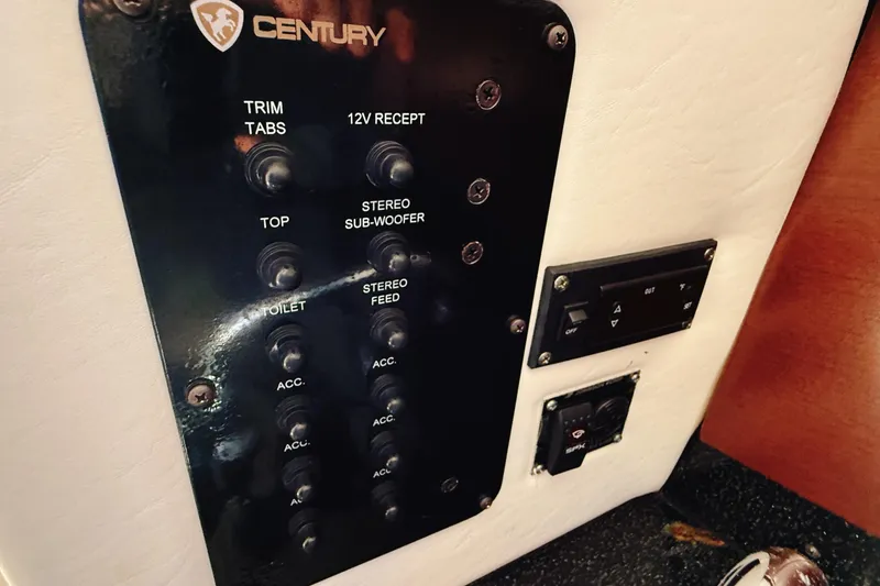 Slide: The Image of Control panel of a 2016 Century 2600 Walkaround boat with various switches. - 27
