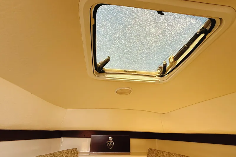 Slide: The Image of Interior cabin view of a 2016 Century 2600 Walkaround boat with a skylight. - 28
