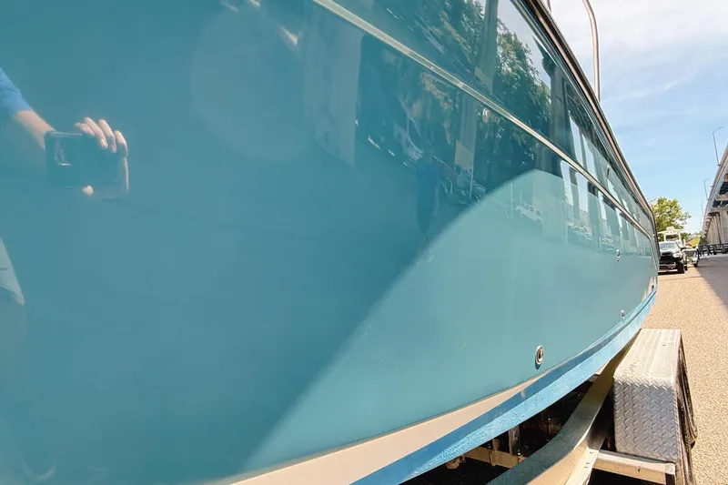 Slide: The Image of 2016 Century 2600 Walkaround boat on trailer, side view with blue hull. - 4