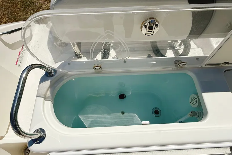 Slide: The Image of Livewell on a 2016 Century 2600 Walkaround boat, featuring a clear lid and stainless steel handle. - 9
