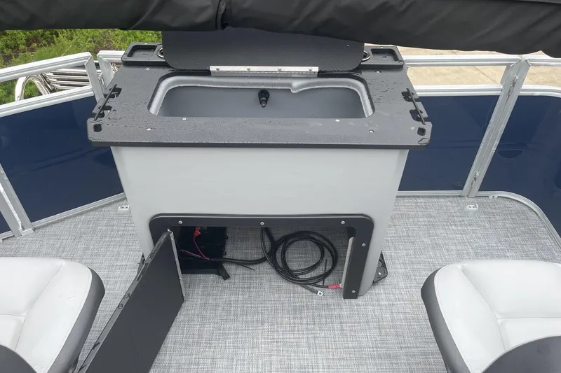 Slide: The Image of 2026 Sun Tracker SportFish 20 DLX boat interior with storage compartment and seating. - 8
