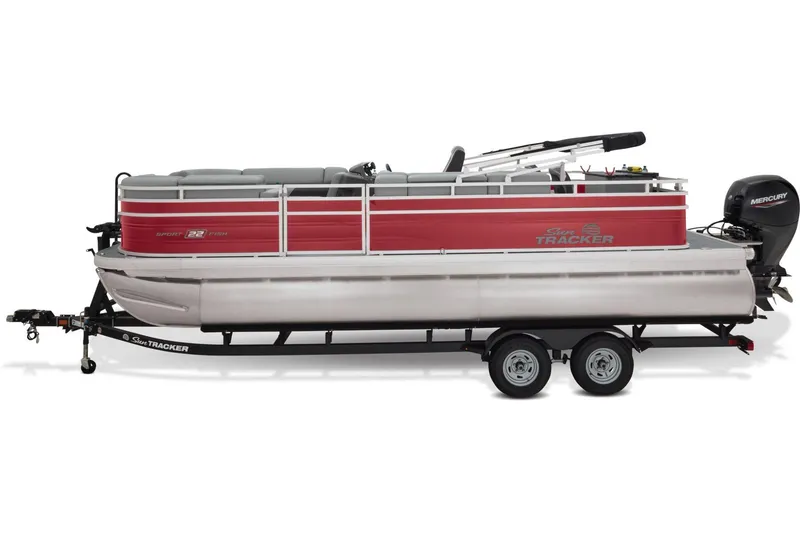 Slide: The Image of 2026 Sun Tracker SportFish 22 DLX pontoon boat with outboard motor in a parking lot. - 6