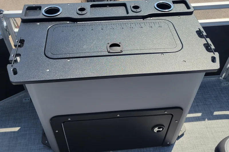 Slide: The Image of 2026 Sun Tracker SportFish 20 DLX fishing station with rod holders and storage compartment. - 3