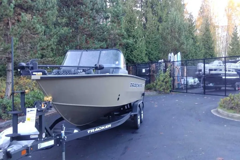Slide: The Image of 2026 Tracker Targa V-19 Combo boat on trailer, side view, beige color. - 2