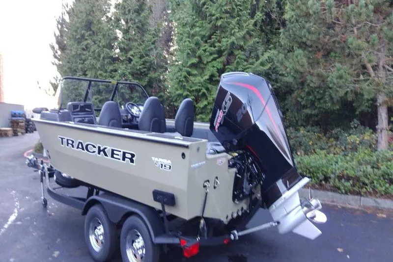 Slide: The Image of 2026 Tracker Targa V-19 Combo boat on trailer, parked near trees. - 3