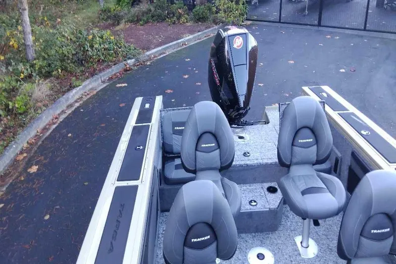 Slide: The Image of 2026 Tracker Targa V-19 Combo boat interior with seating and motor. - 8