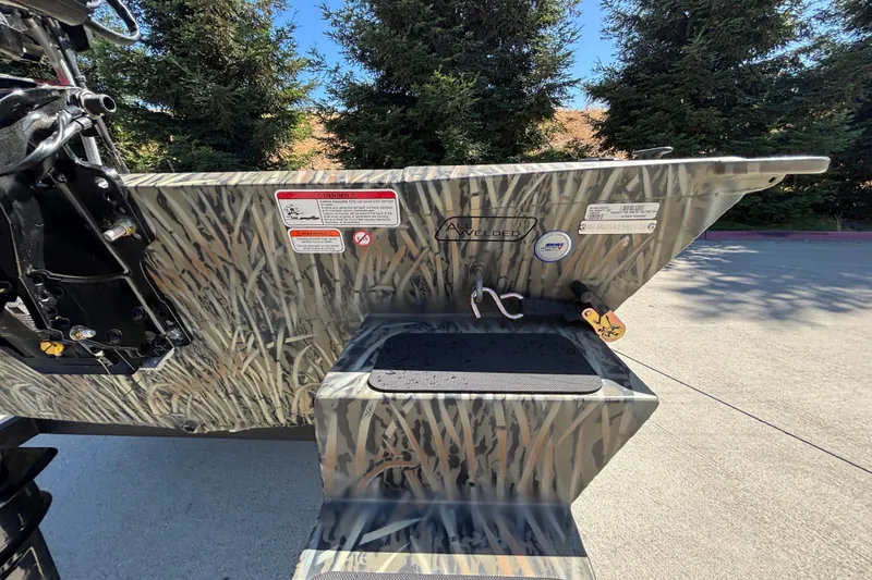 Slide: The Image of 2026 Tracker Grizzly 1654 T Sportsman boat with camouflage pattern and welded aluminum hull. - 11