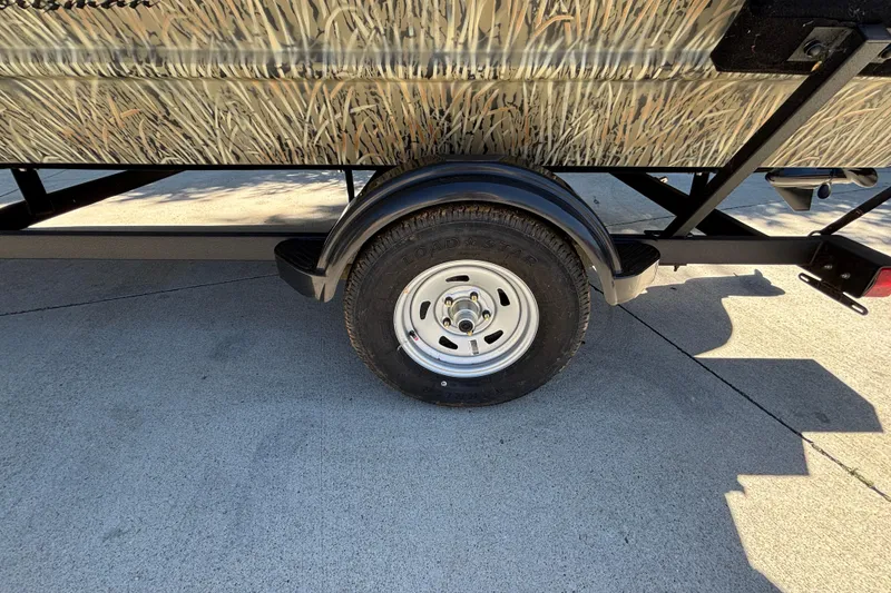 Slide: The Image of Trailer wheel of 2026 Tracker Grizzly 1654 T Sportsman on concrete surface. - 16