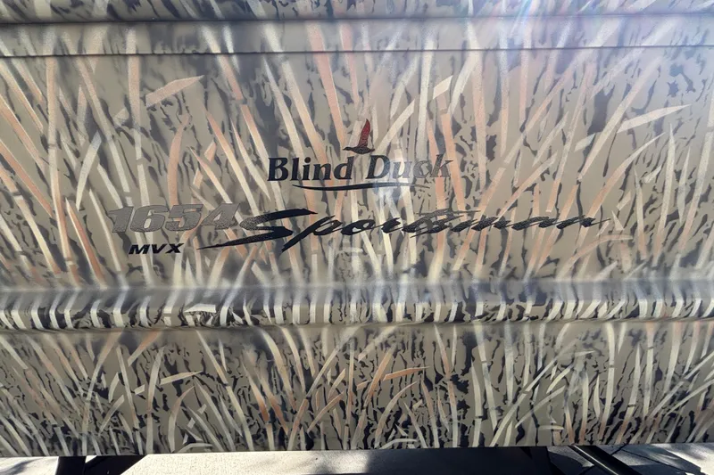 Slide: The Image of 2026 Tracker Grizzly 1654 T Sportsman boat with camo design and "Blind Duck" branding. - 21