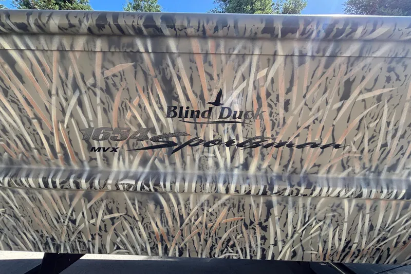 Slide: The Image of 2026 Tracker Grizzly 1654 T Sportsman boat with camo design and "Blind Duck" branding. - 15