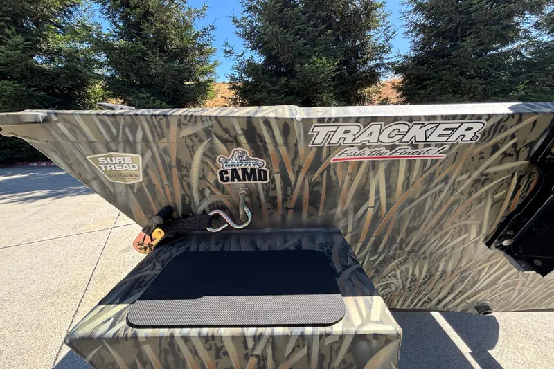 Slide: The Image of 2026 Tracker Grizzly 1654 T Sportsman boat with camo design and branding decals. - 12
