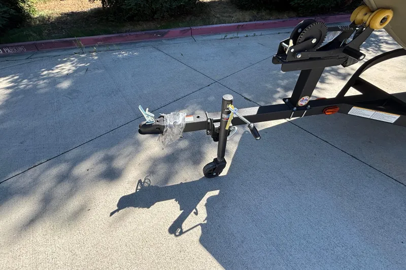 Slide: The Image of Trailer hitch of 2026 Tracker Grizzly 1654 T Sportsman on concrete pavement. - 23