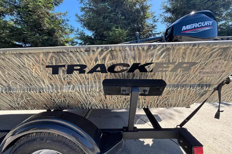 Slide: The Image of 2026 Tracker Grizzly 1654 T Sportsman boat with camo design and Mercury engine. - 20