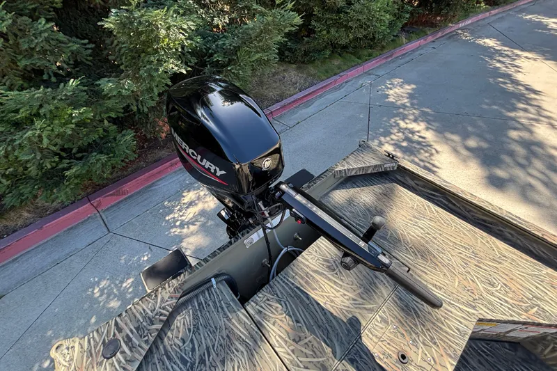 Slide: The Image of 2026 Tracker Grizzly 1654 T Sportsman boat with Mercury outboard motor, camo design. - 18