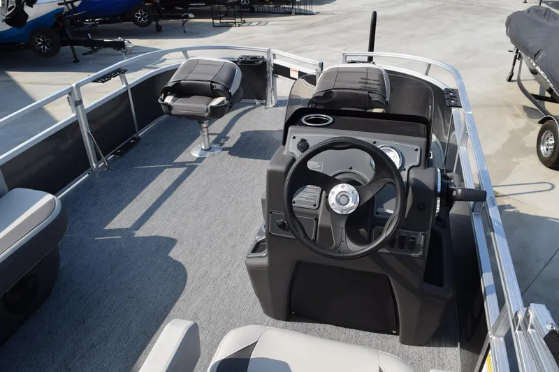 Slide: The Image of 2026 Sun Tracker Bass Buggy 16 XL Select pontoon boat interior with steering console. - 5