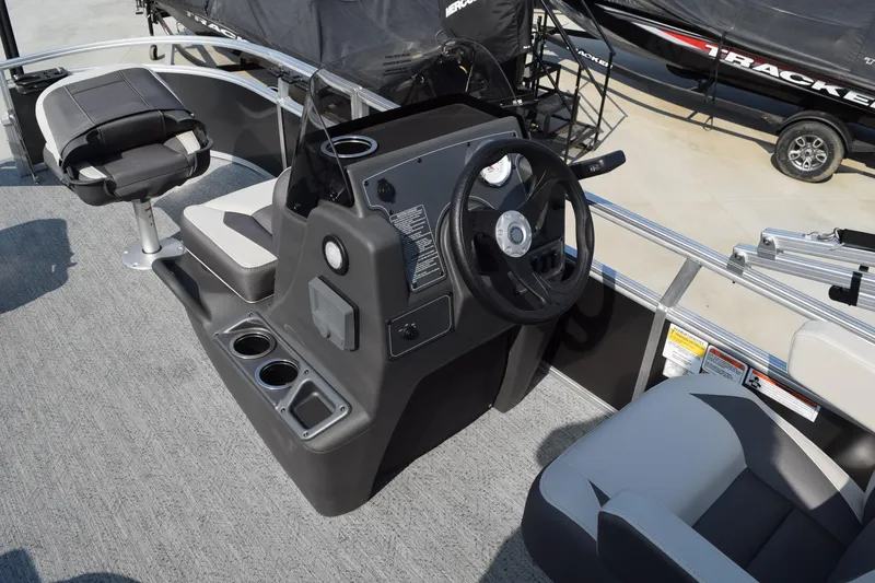 Slide: The Image of 2026 Sun Tracker Bass Buggy 16 XL Select boat interior with steering console and seating. - 6