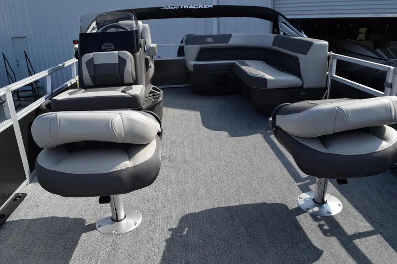 Slide: The Image of 2026 Sun Tracker Bass Buggy 16 XL Select pontoon boat interior with seating and helm. - 7