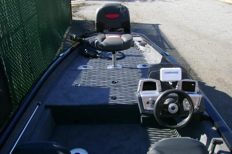 Slide: The Image of 2026 Tracker Pro Team 175 Crappie Edition boat interior with steering console and seating. - 4