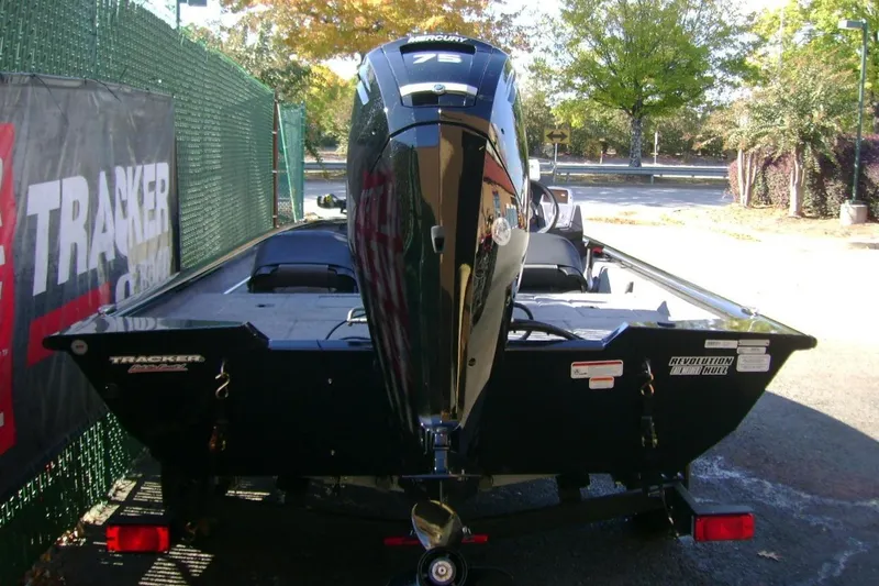 Slide: The Image of 2026 Tracker Pro Team 175 Crappie Edition boat with Mercury engine, parked outdoors. - 6