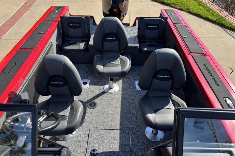 Slide: The Image of 2026 Tracker Targa V-19 Combo boat interior with four black seats and red accents. - 7