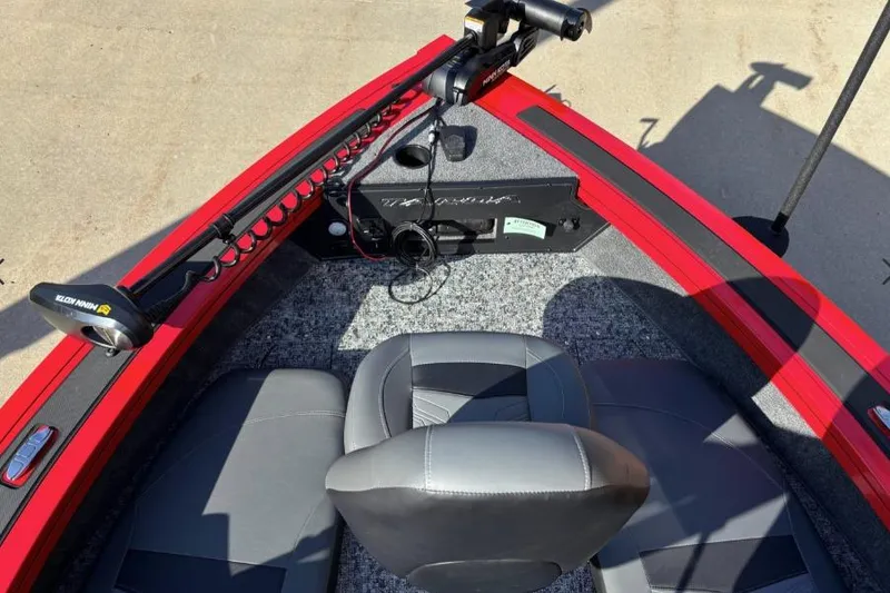 Slide: The Image of 2026 Tracker Targa V-19 Combo boat interior with red trim and seating. - 8