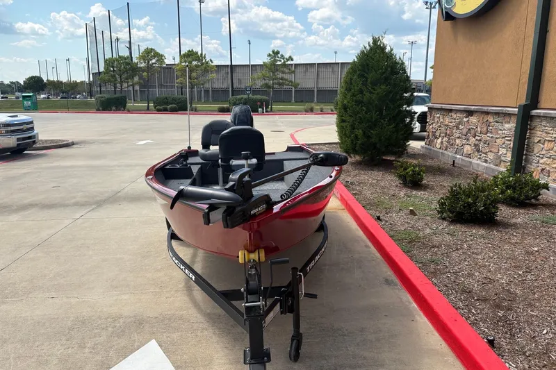 Slide: The Image of 2026 Tracker Super Guide V-16 T boat on trailer in parking lot. - 2