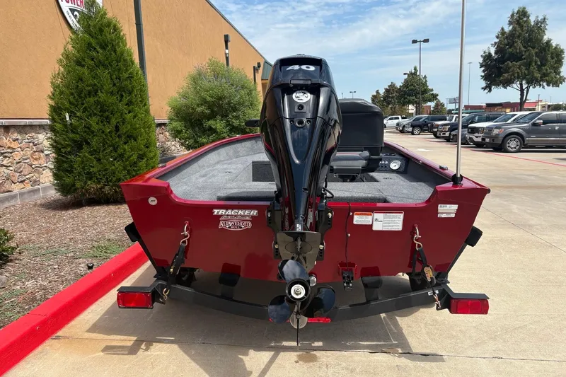 Slide: The Image of 2026 Tracker Super Guide V-16 T boat with outboard motor, parked outdoors. - 3