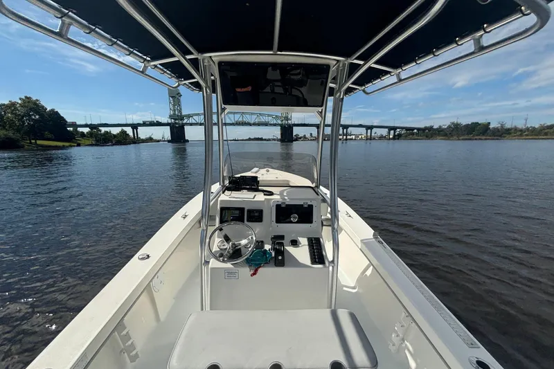 Slide: The Image of 2023 Maycraft 2100 CC boat on calm water near a bridge, sunny day. - 8