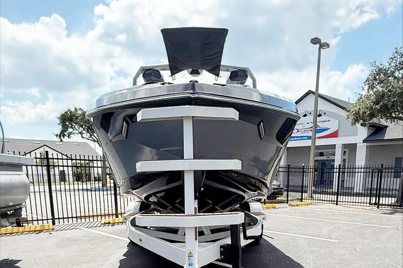 Slide: The Image of 2025 Nautique Super Air Nautique S21 boat on trailer, parked outdoors. - 4