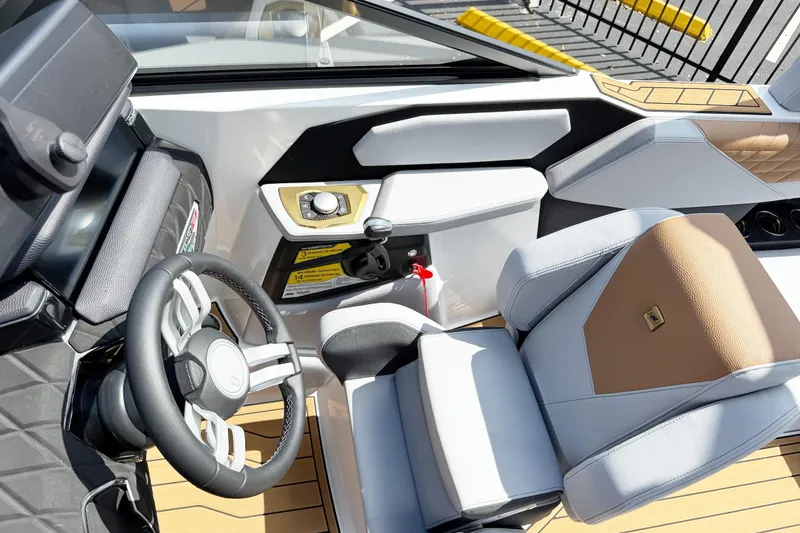 Slide: The Image of 2025 Nautique Super Air Nautique S21 cockpit with modern steering and luxurious seating. - 5