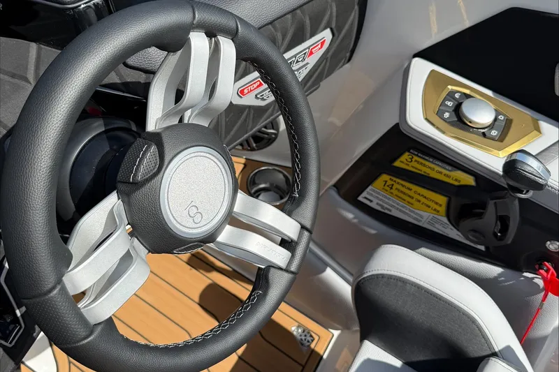 Slide: The Image of 2025 Nautique Super Air Nautique S21 steering wheel and control panel close-up. - 6