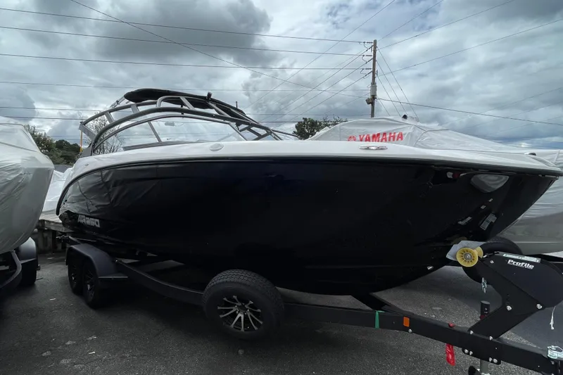 The Image of 2026 Yamaha AR250 boat on trailer under cloudy sky. - 1