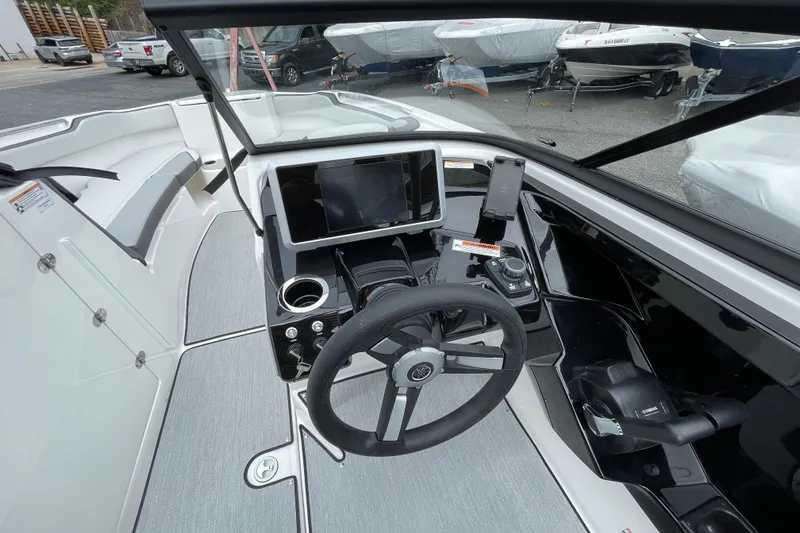 Slide: The Image of 2026 Yamaha AR250 boat cockpit with steering wheel, touchscreen, and controls. - 11