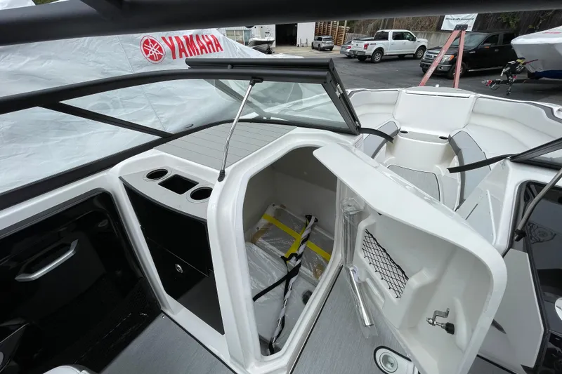Slide: The Image of 2026 Yamaha AR250 boat interior with storage compartment and seating area. - 12