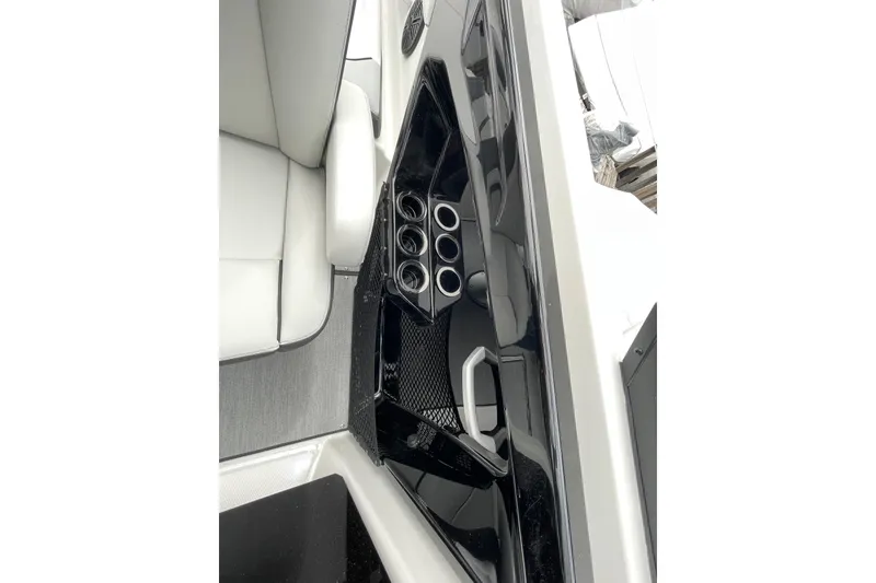 Slide: The Image of 2026 Yamaha AR250 boat interior with cup holders and sleek seating design. - 17