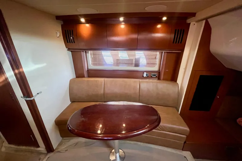 Slide: The Image of Luxurious interior of 2007 Sea Ray 38 Sundancer yacht with leather seating and wooden table. - 10