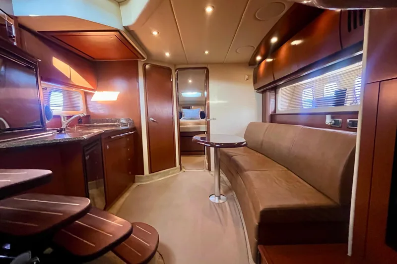 Slide: The Image of Luxurious interior of 2007 Sea Ray 38 Sundancer yacht with kitchen and seating area. - 11