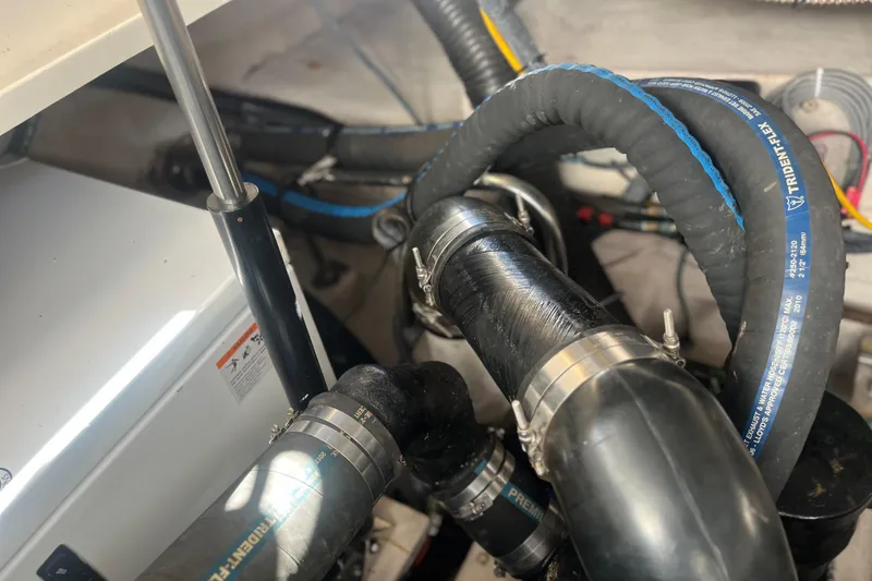 Slide: The Image of Engine compartment of 2007 Sea Ray 38 Sundancer with hoses and clamps visible. - 18