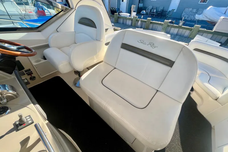 Slide: The Image of 2007 Sea Ray 38 Sundancer cockpit with white seating and steering wheel. - 6