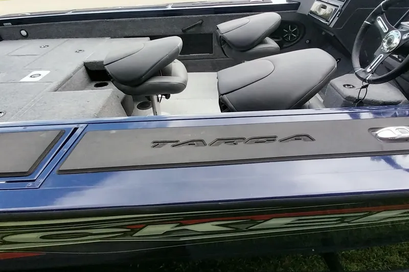 Slide: The Image of 2024 Tracker Targa V-18 Combo boat interior with seating and steering wheel. - 12