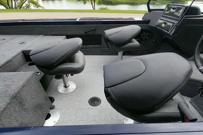 Slide: The Image of 2024 Tracker Targa V-18 Combo boat interior with sleek seating and modern dashboard. - 13