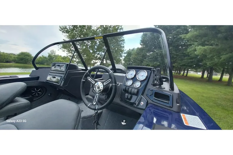 Slide: The Image of 2024 Tracker Targa V-18 Combo boat interior with steering wheel and dashboard controls. - 14