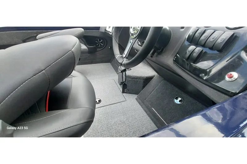 Slide: The Image of 2024 Tracker Targa V-18 Combo boat interior with steering wheel and control panel. - 16