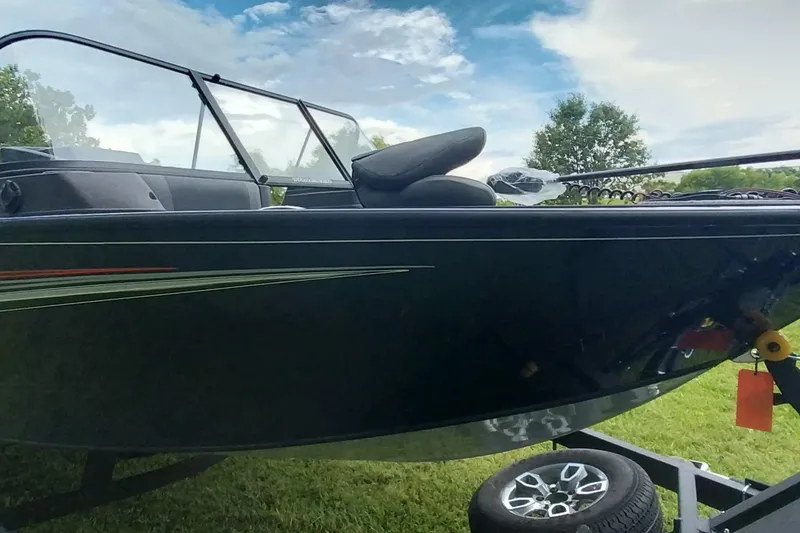 Slide: The Image of 2024 Tracker Targa V-18 Combo boat on trailer, side view with windshield. - 18
