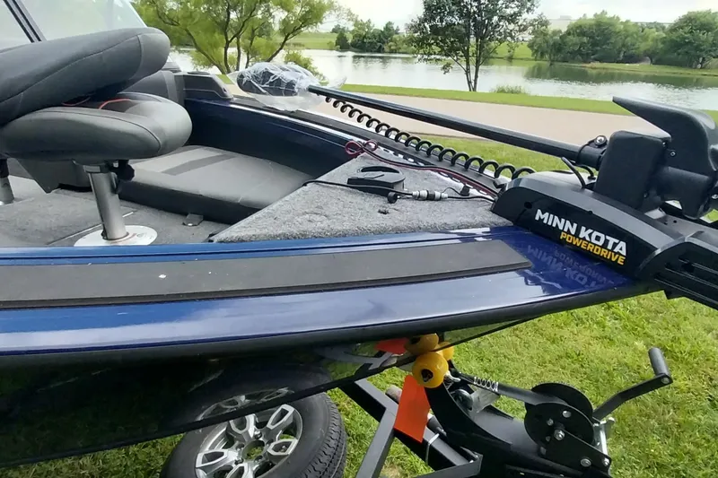 Slide: The Image of 2024 Tracker Targa V-18 Combo boat with Minn Kota PowerDrive, parked near a scenic lake. - 20